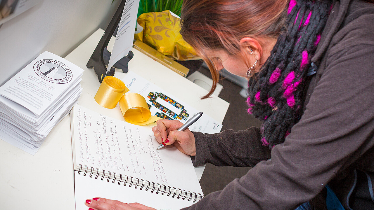 Visitors sign the guest book