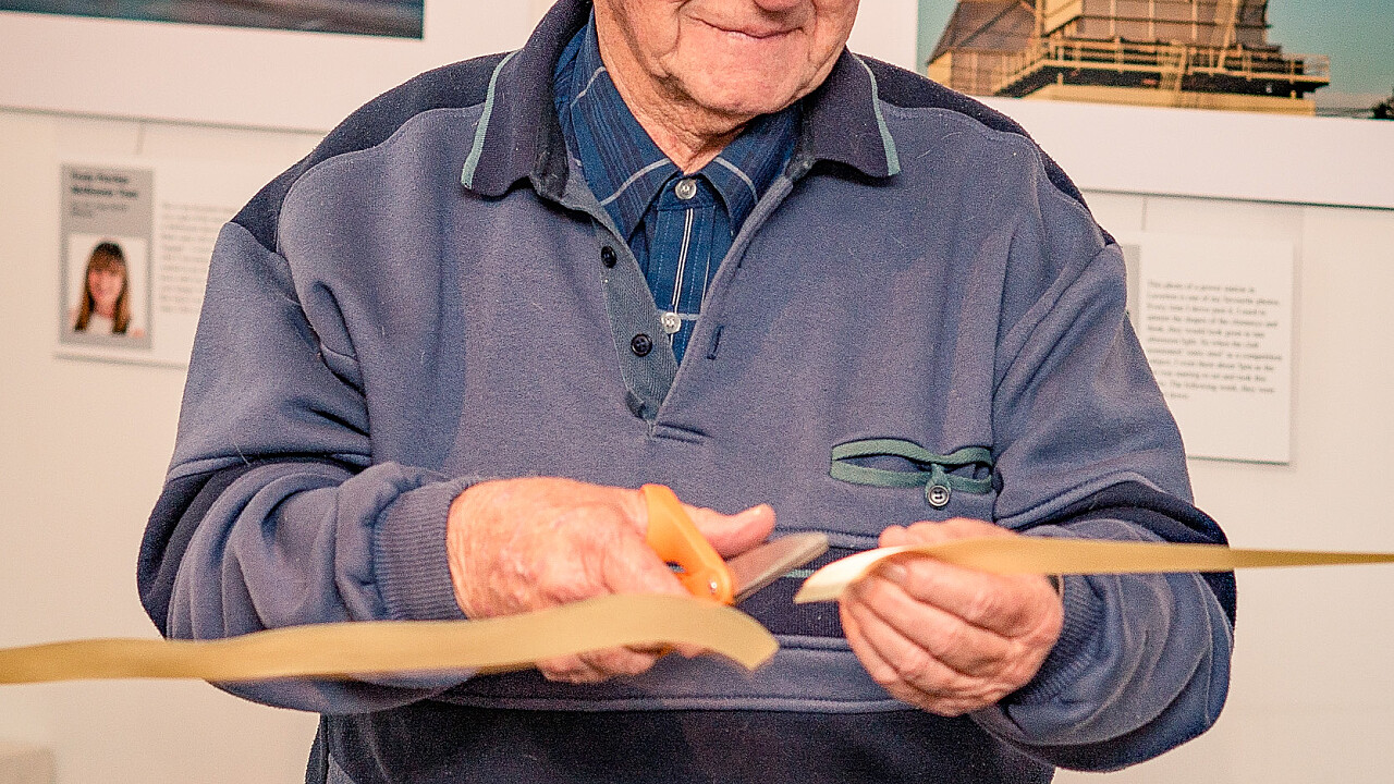 Club Founder Trevor Young cuts the ribbon formally opening the Williamstown Camera Club 50th Anniversary Exhibition