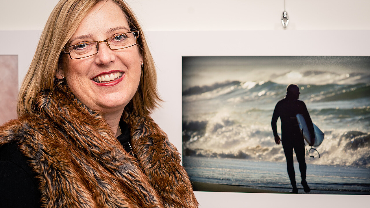 Andrea Sparks with her image at the 50th Anniversary Exhibition